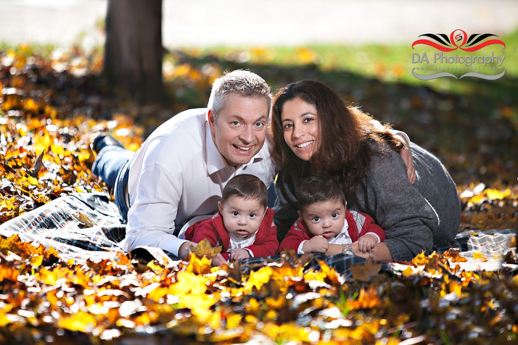 Family at the yellow leaves one autumn day