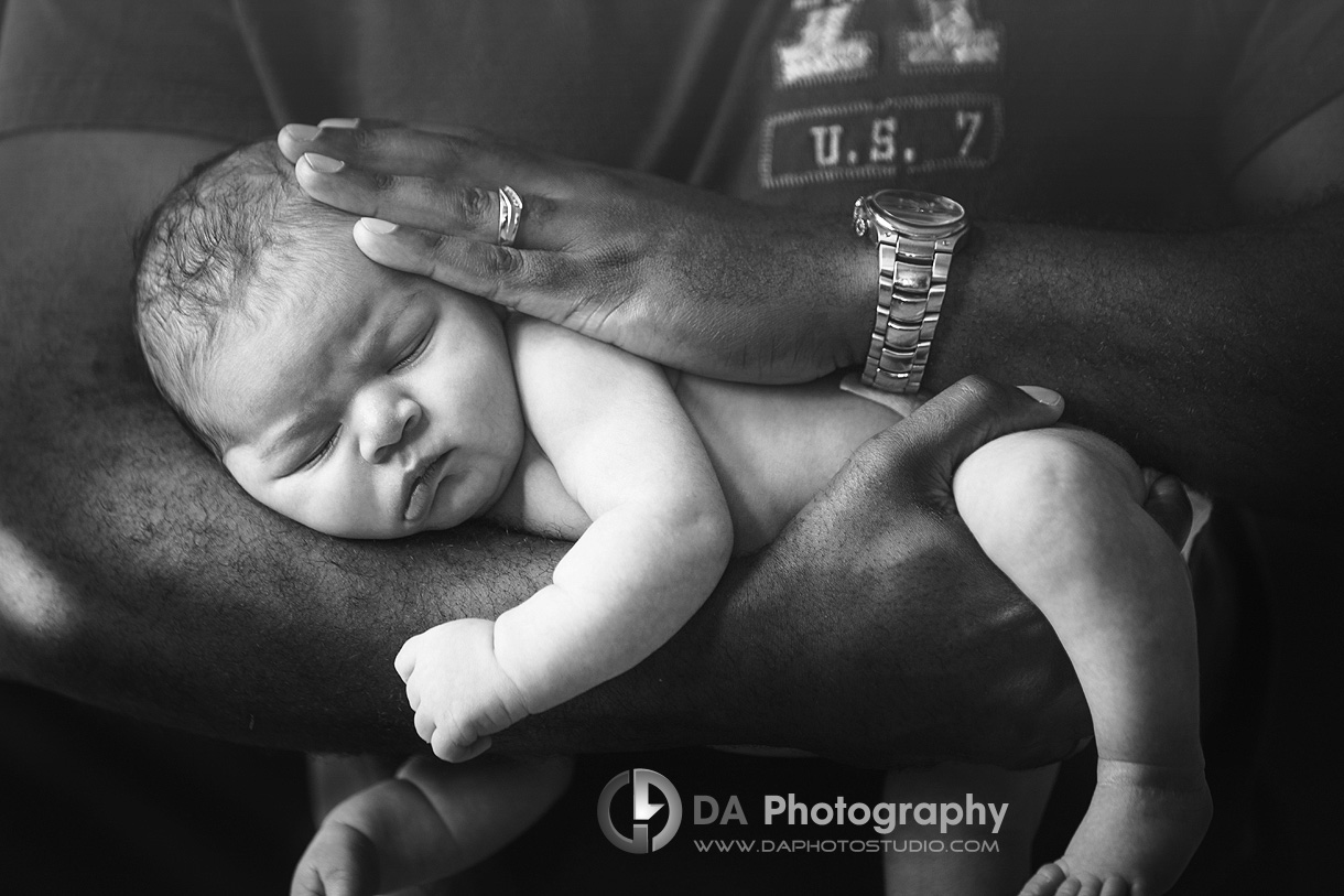 Newborn baby held by his father as football - Newborn Local Photographer