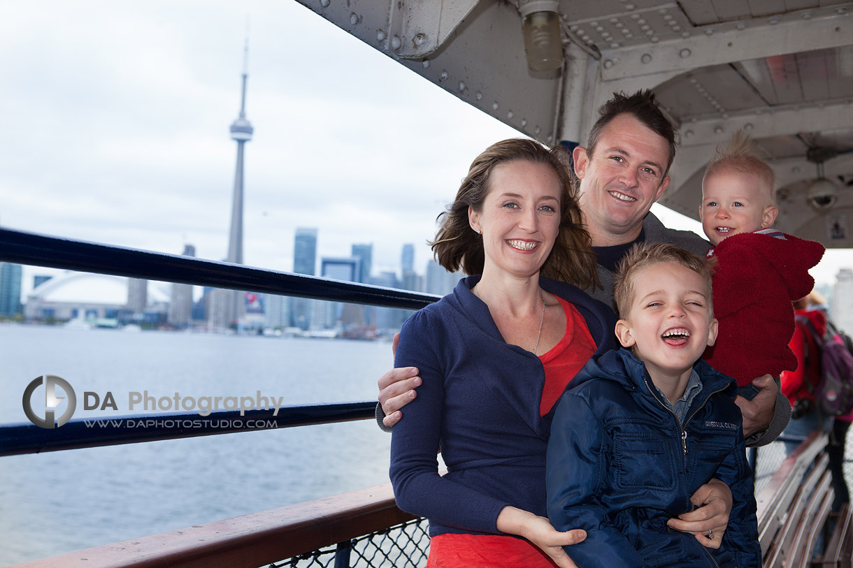 Family at the ferry with CN tower at the back - DA Photography at Toronto Islands, www.daphotostudio.com