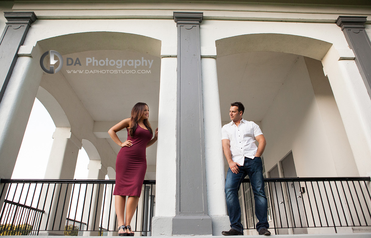 Architecture incorporate with engagement couple  - By DA Photography at LaSalle Park and Marina in Burlington