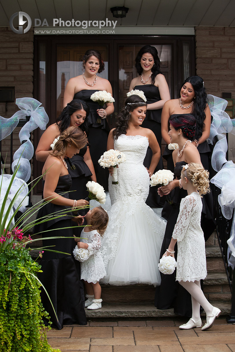 Bride with her bridal party onto her parents staircase - Wedding Photography by Dragi Andovski at Erchelss Estate, Oakville