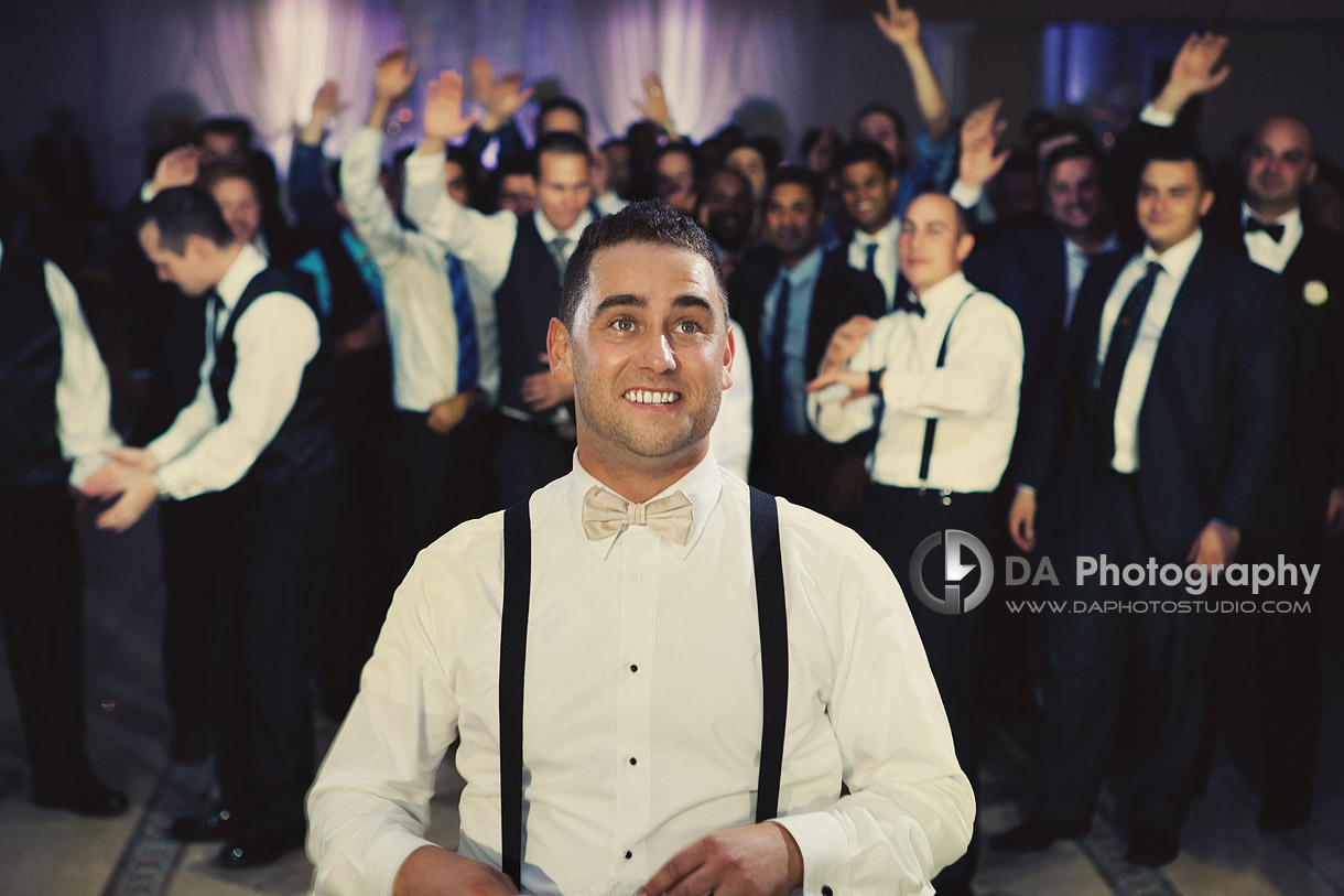 Groom teasing garter toss - Wedding Photography by Dragi Andovski at Erchelss Estate, Oakville