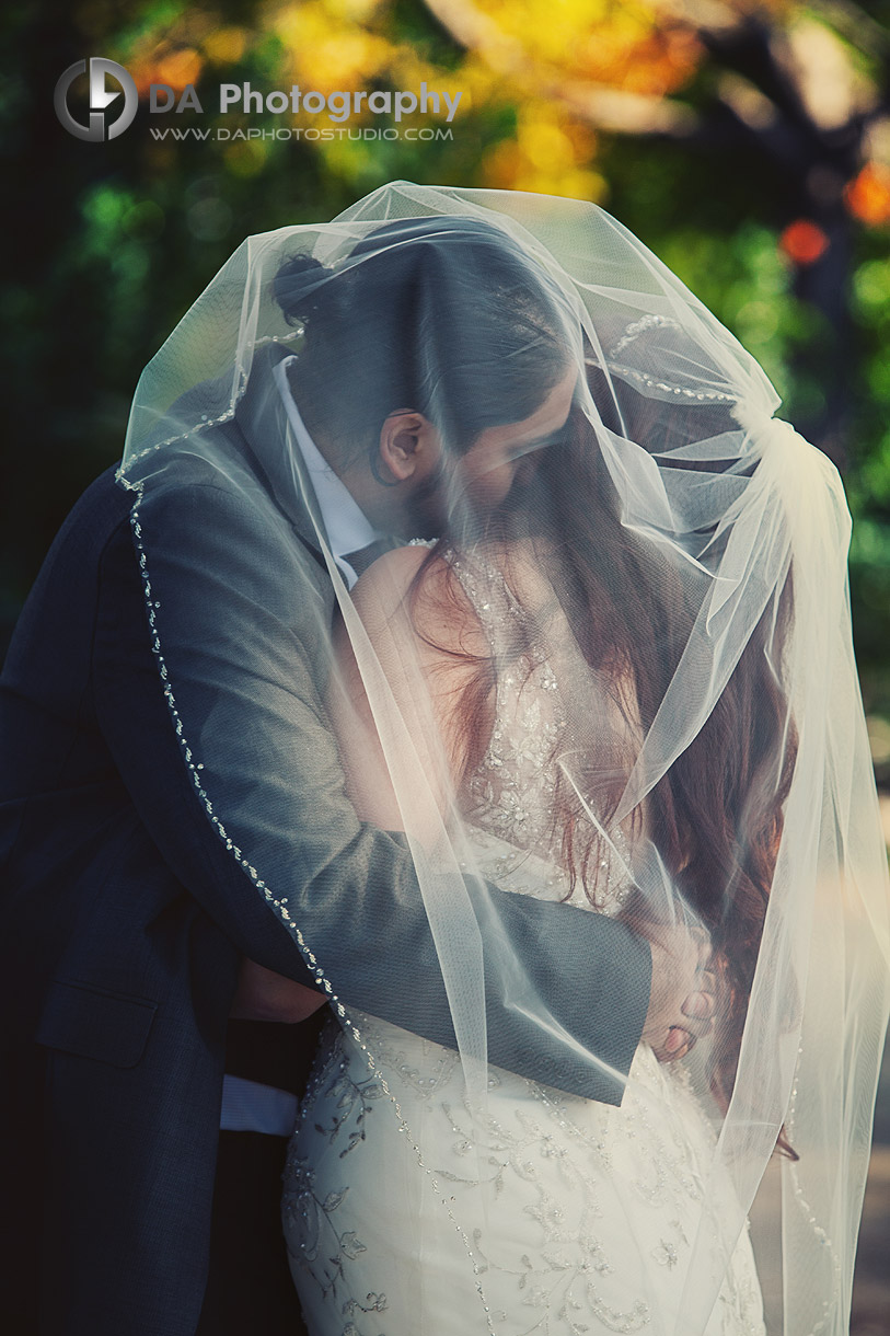 Groom and Bride kiss under the veil - by DA Photography at Black Creek Pioneer Village, www.daphotostudio.com