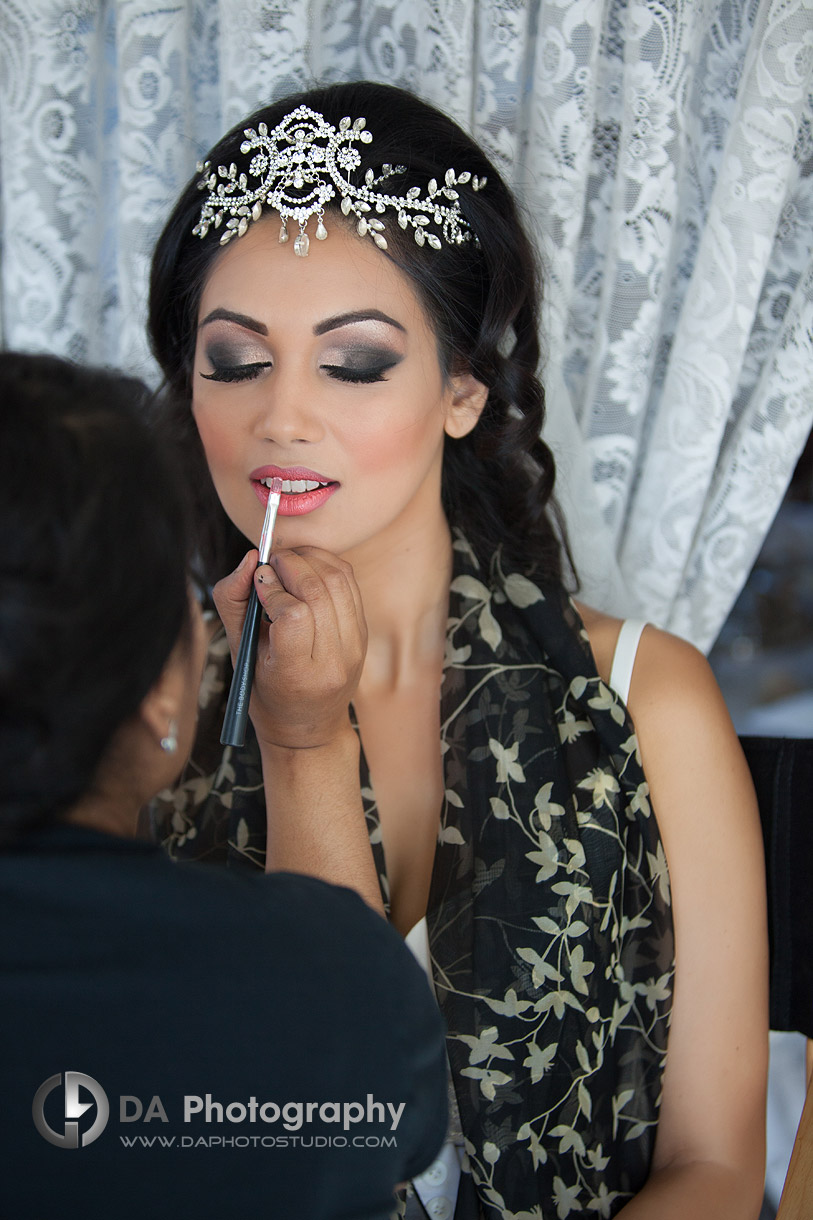 Bride is getting ready, final make up touches - by DA Photography at West River, www.daphotostudio.com