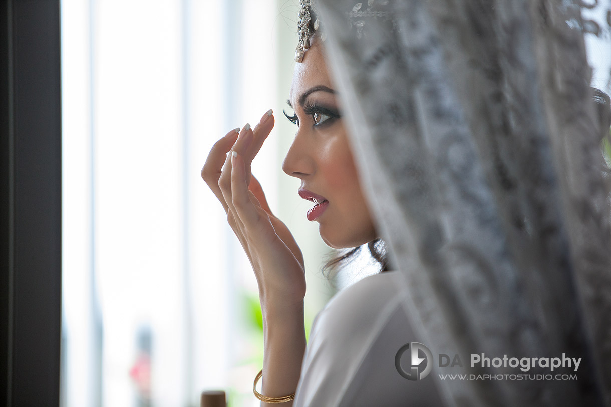 Wedding day, bride is getting ready, final make up touches - by DA Photography at West River, www.daphotostudio.com