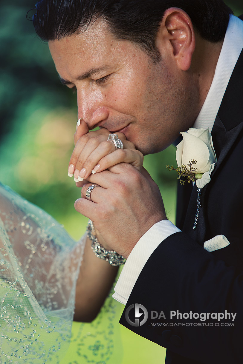 Groom is kissing his bride's hand - by DA Photography at West River, www.daphotostudio.com