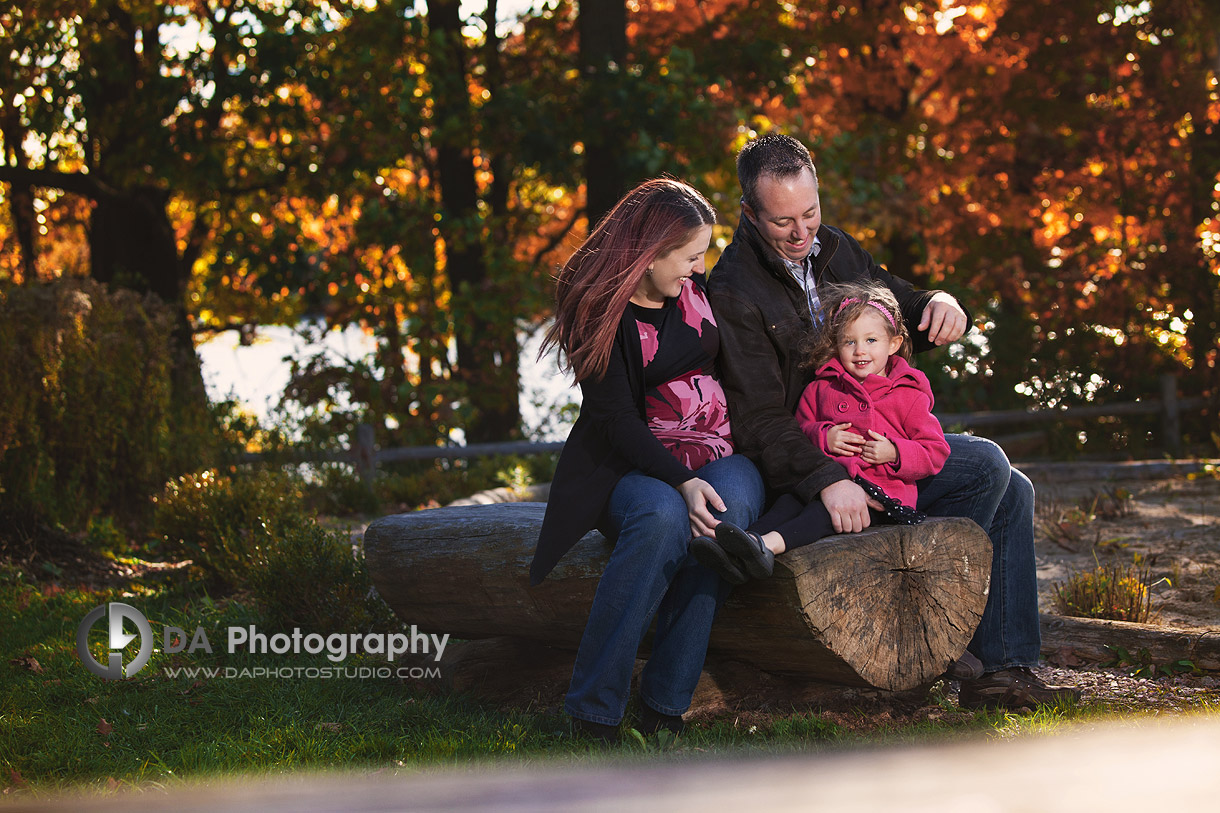 Young family in Fall at the wooden log - at Heart Lake Conservation Area by DA Photography - www.daphotostudio.com