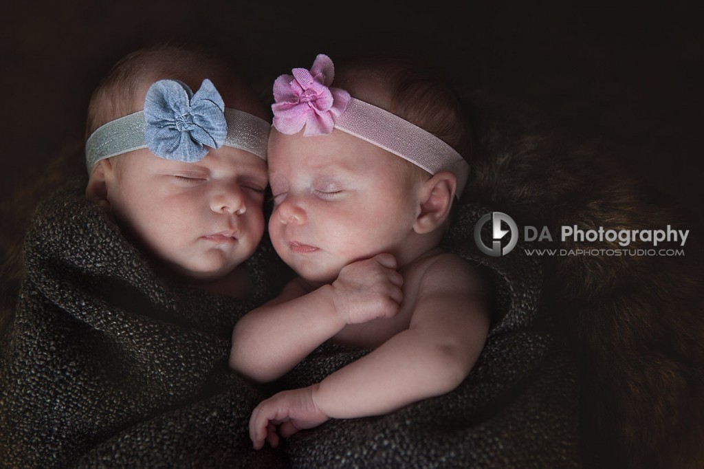Twin newborn sisters snuggled together -Newborn babies by DA Photography - www.daphotostudio.com