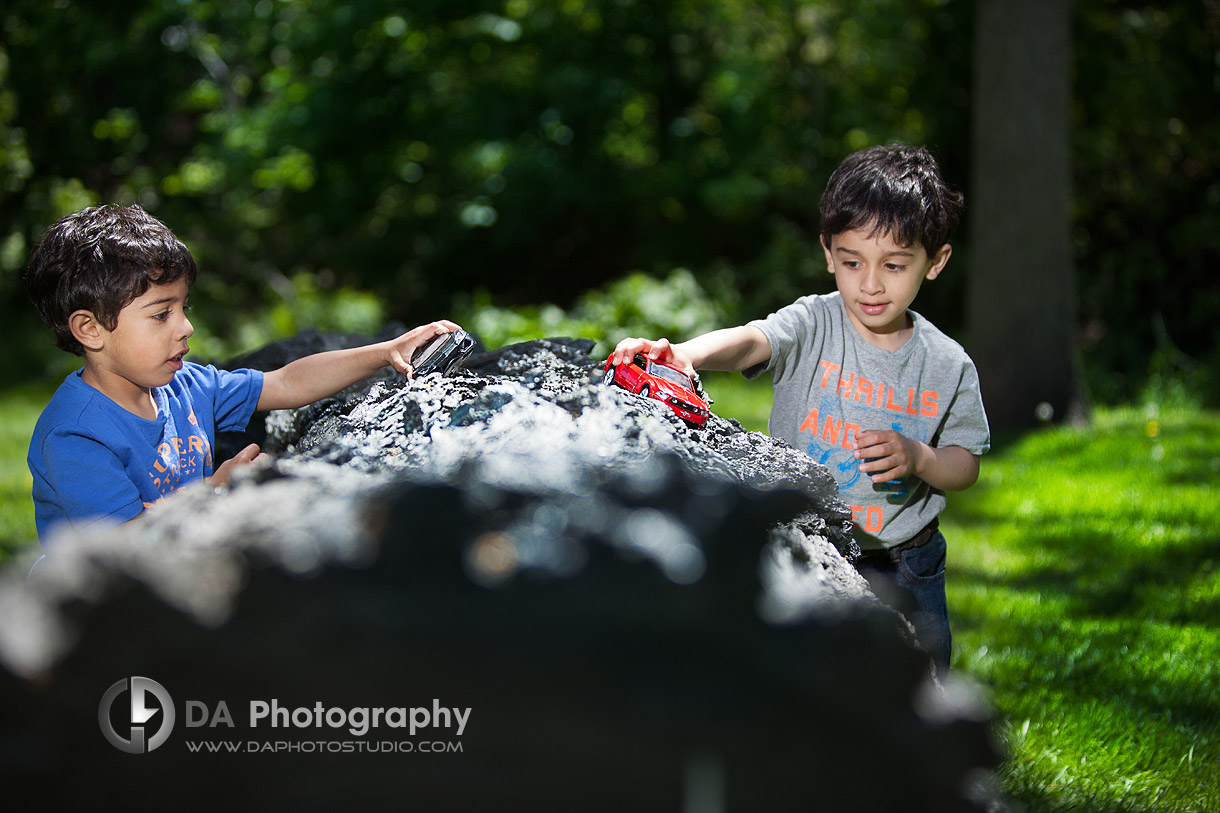 Two boys with their car game - by DA Photography - Gairloch Gardens, ON - www.daphotostudio.com