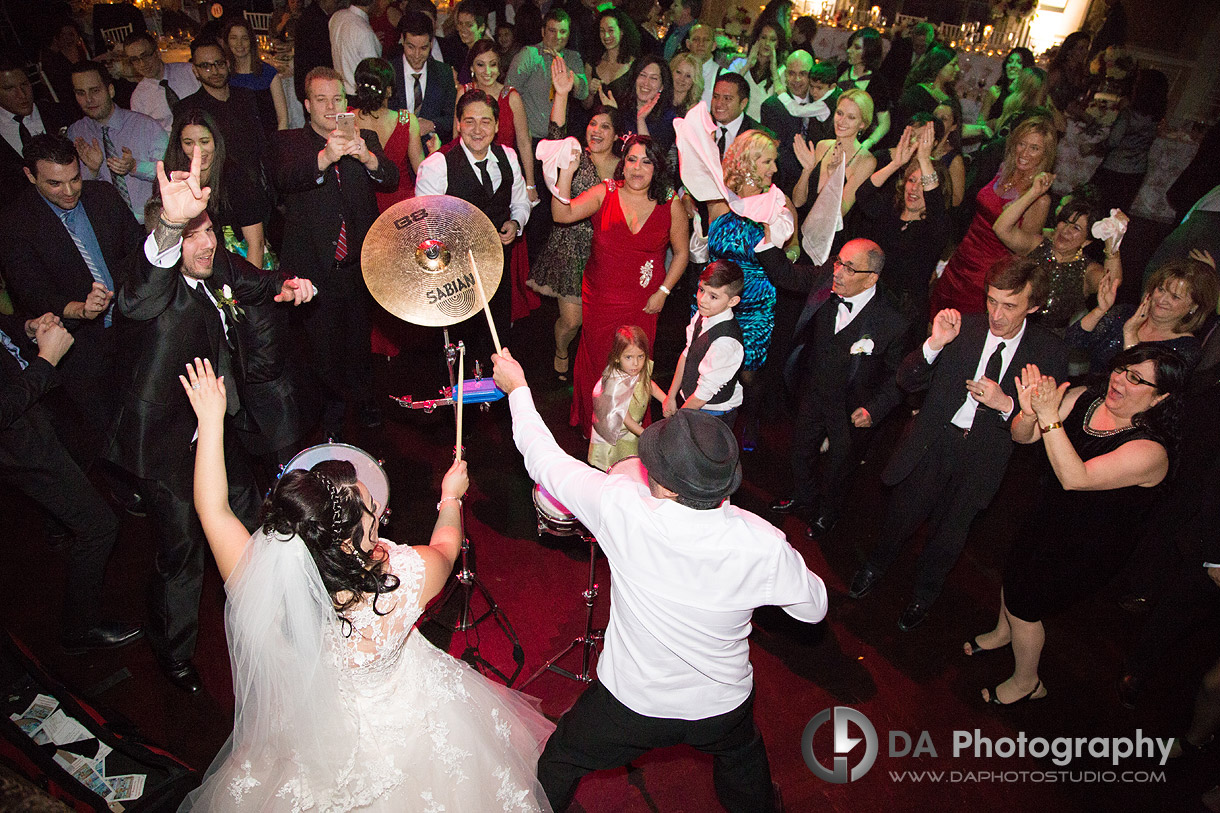 Bride drumming durning her wedding and getting the party started - Winter wedding at Liberty Grand by DA Photography , www.daphotostudio.com