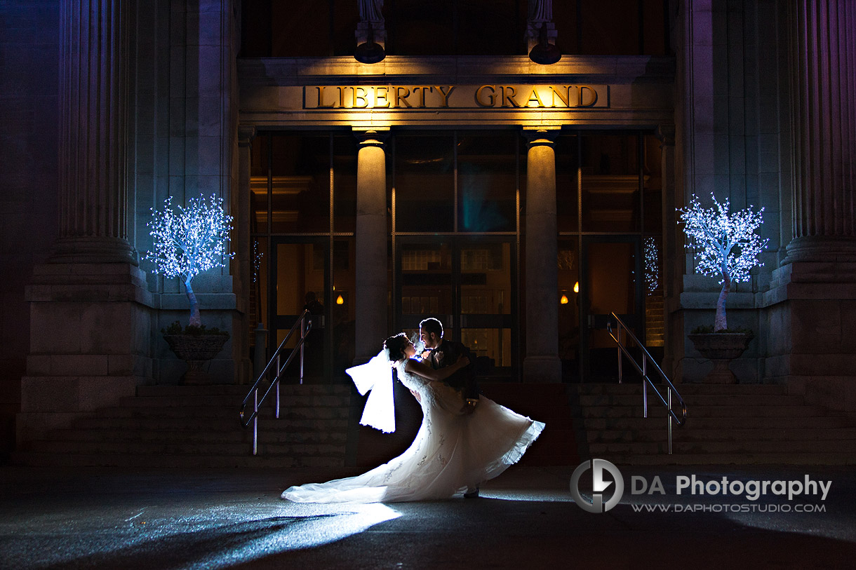 Bride and Groom at the front of Liberty Grand - Winter wedding at Liberty Grand by DA Photography , www.daphotostudio.com