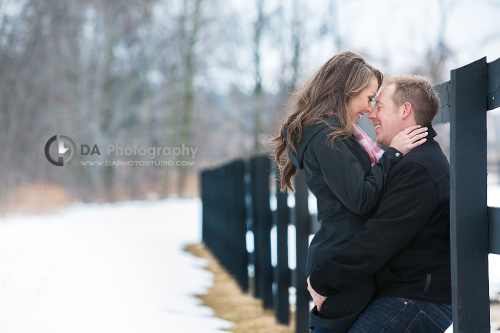 A kiss by the fence - Romantic engagement photos by DA Photography at Parish Ridge Stables in Burlington , www.daphotostudio.com