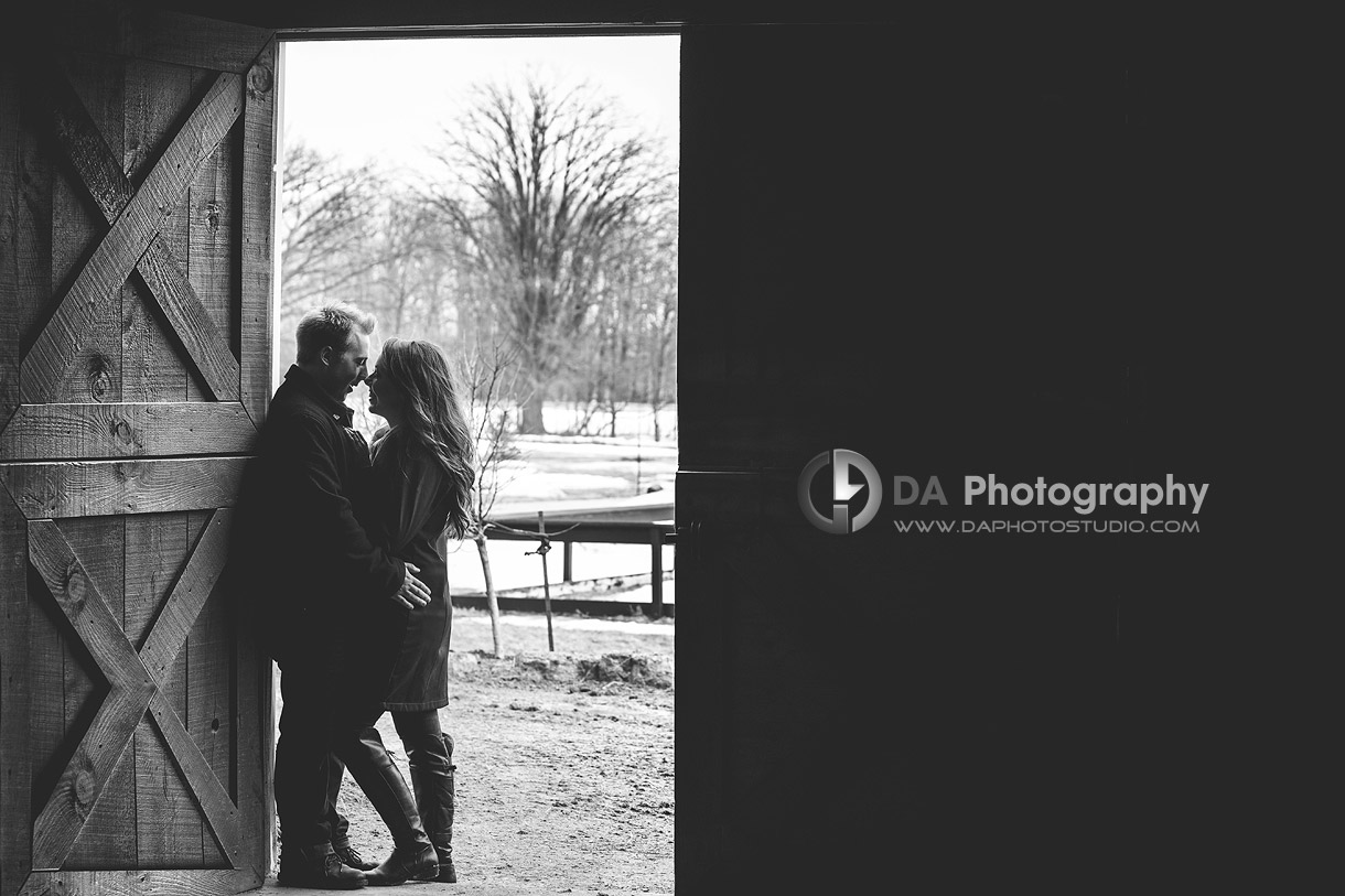 Barn Door Snuggle - Romantic engagement photos by DA Photography at Parish Ridge Stables in Burlington , www.daphotostudio.com