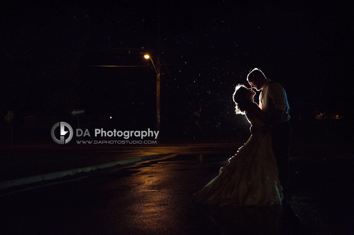 Bride and Groom Kiss under the open rainy sky at Weddings in Port Dover
