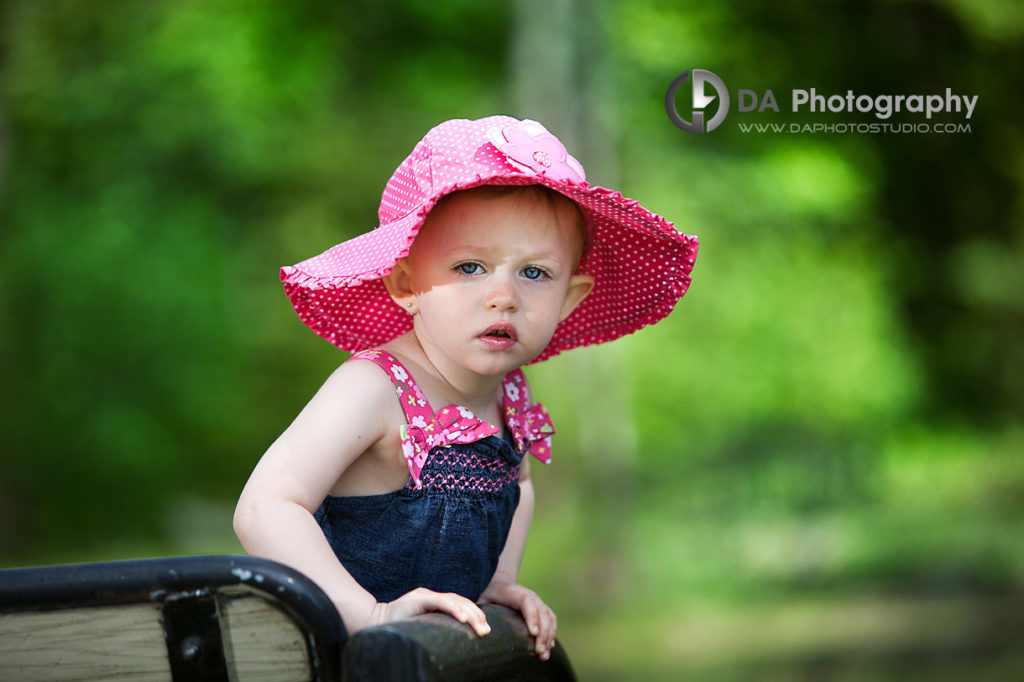 Little girl with her colourful hat and her blue eyes - Outdoor Photo Shoot by DA Photography, www.daphotostudio.com
