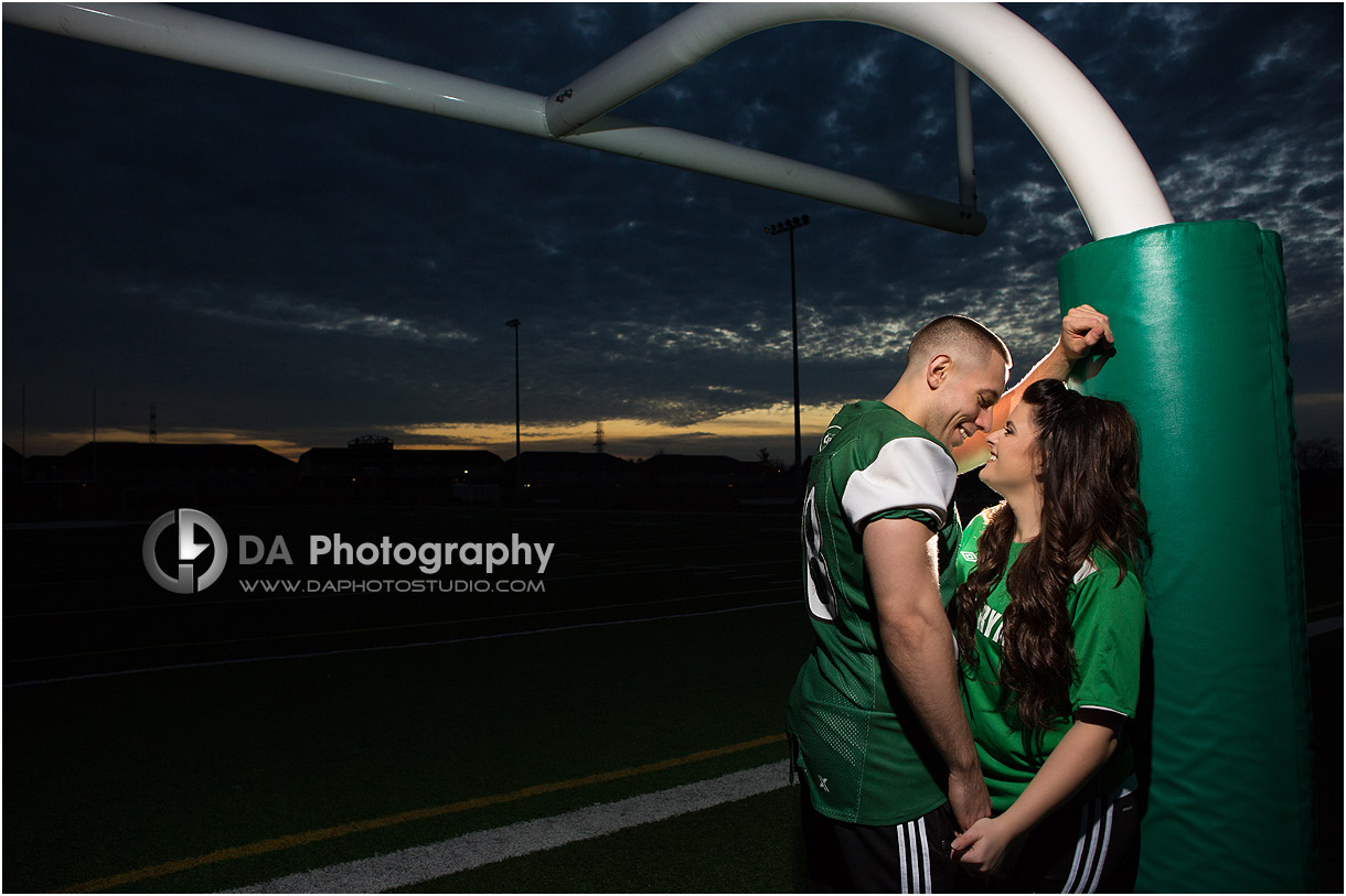 High school engagement at sunset at the football field