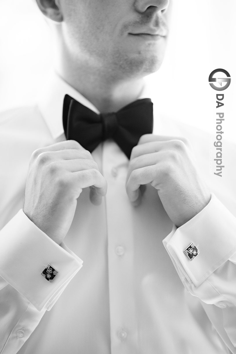 Photo of a Groom fixing his bow tie