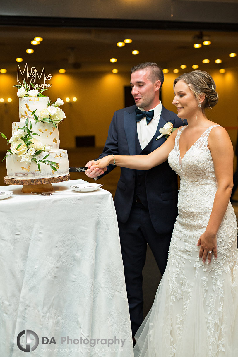 Bride and groom cut cake at The Manor