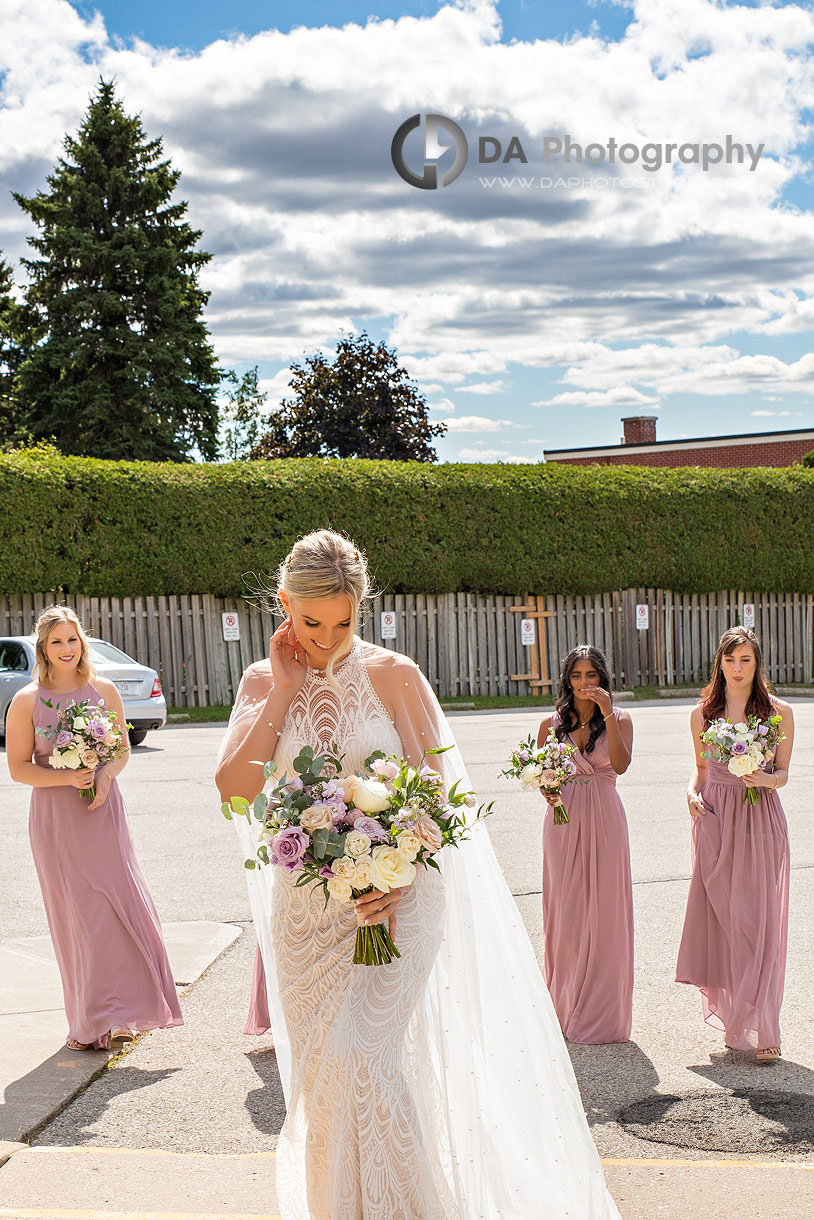 Bride with bridesmaids at Holy Rosary Church in Guelph