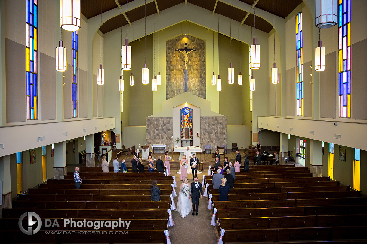 Wide angle photo of a Bride and groom exiting Church in Guelph