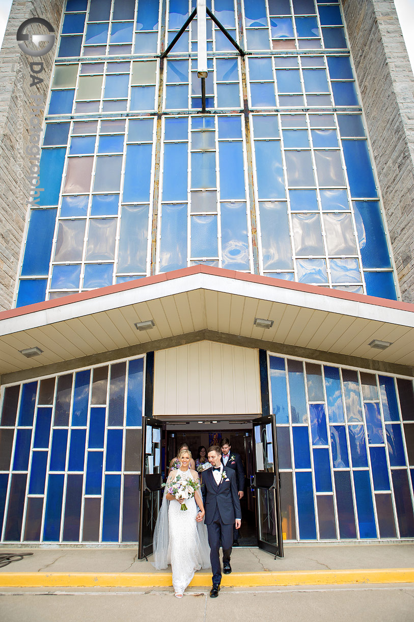 Bride and groom exiting Holy Rosary Church in Guelph