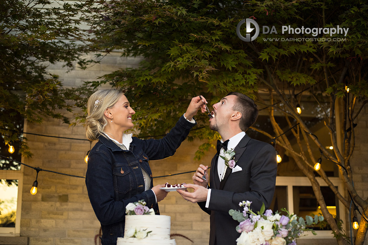 Bride and Groom feed each other a wedding cake