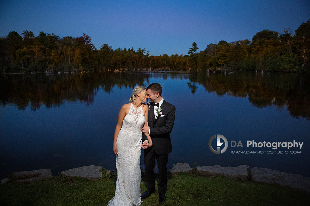 Photo of a bride and groom at twilight by Jedburgh Pond