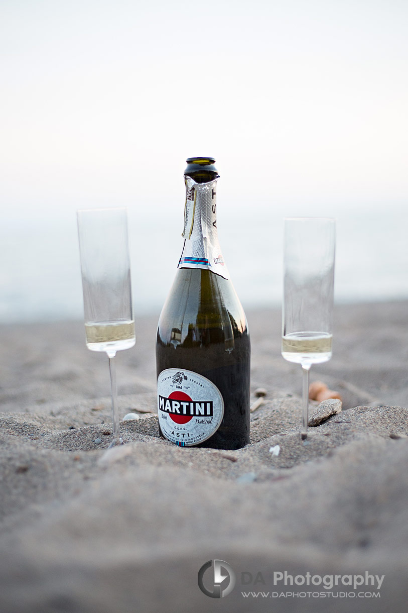 Champagne Bottle with two glasses in the sand