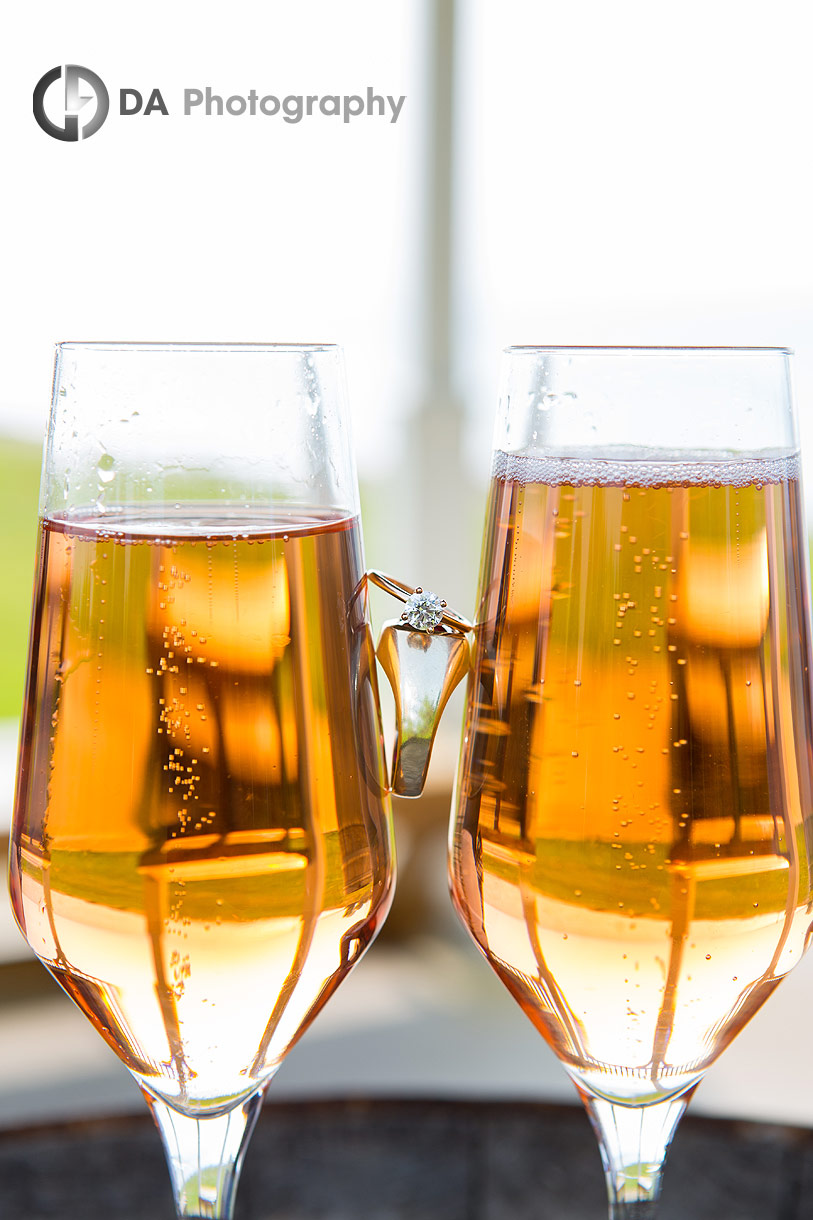 Engagement Ring in between two Champagne glasses