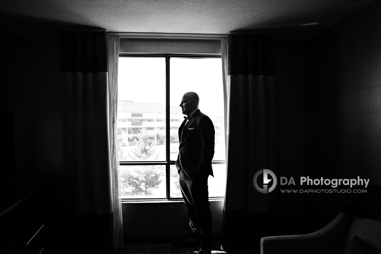 Portrait from a groom in a hotel room