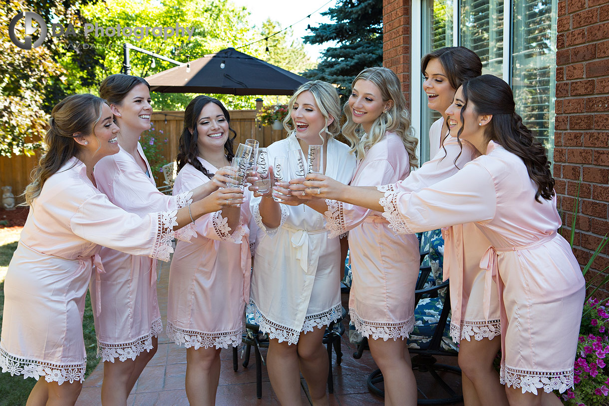 Bridesmaids in a robes drinking champagne