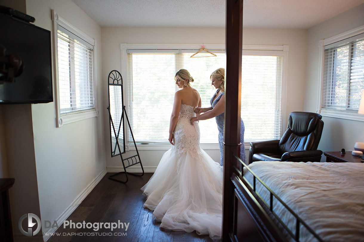 Bride getting her dress up with help of her mom