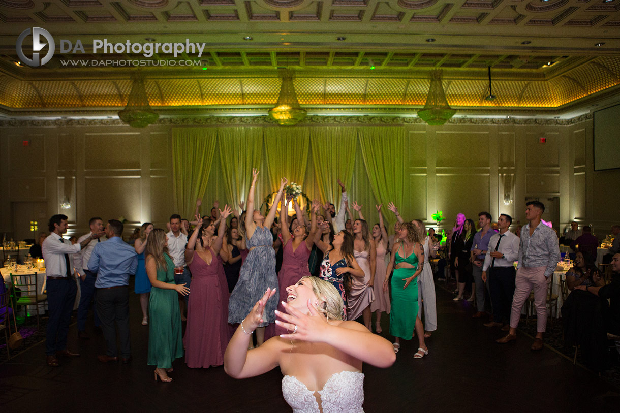 Bride throwing her wedding bouquet at Chateau Le Jardin