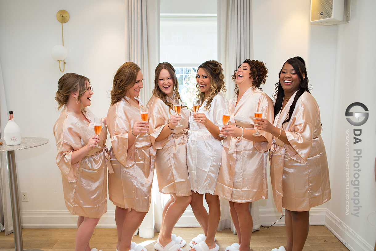 Bridesmaids having a champagne in a robes at Sassafraz