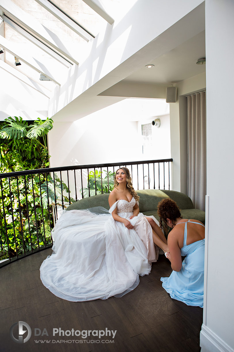 Bride is getting her shoes put on