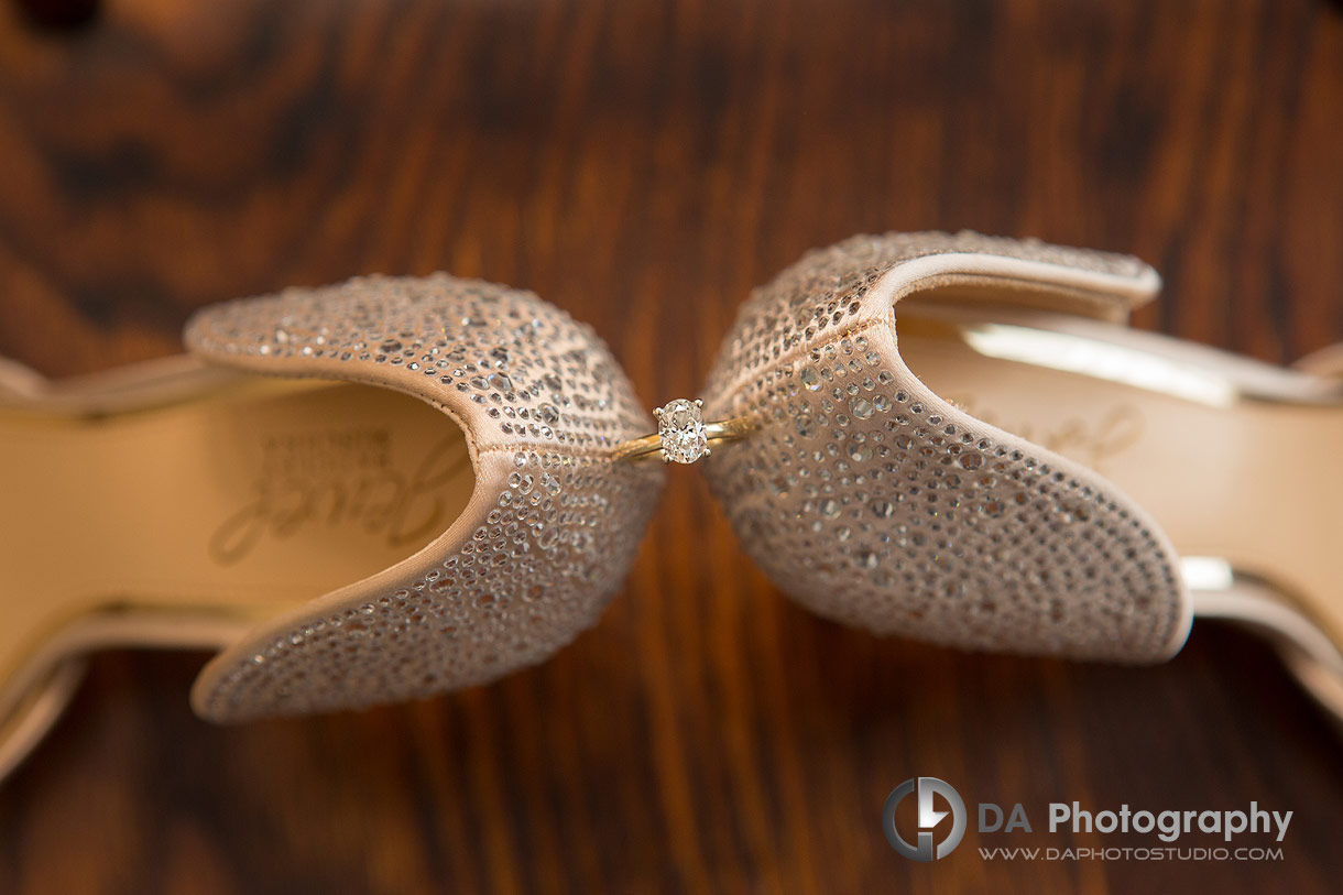 Detail picture of a wedding ring in-between shoes