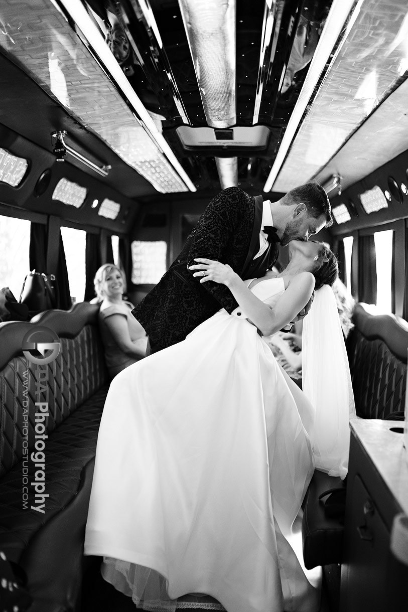 Bride and Groom kiss in the limo