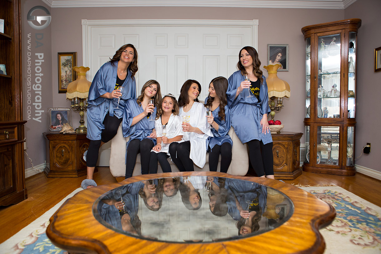 Creative reflection photo of bridesmaids drinking champagne