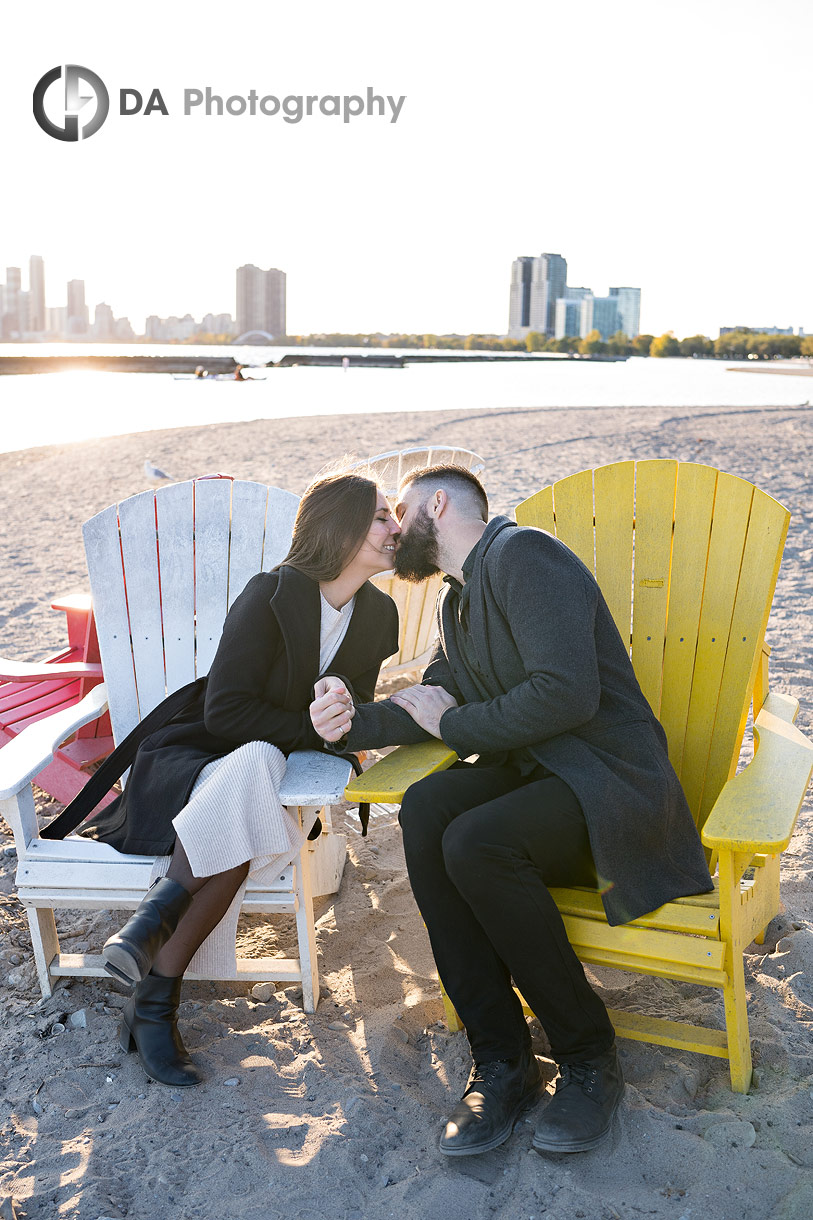 Engaged couple sitting on Muskoka chairs