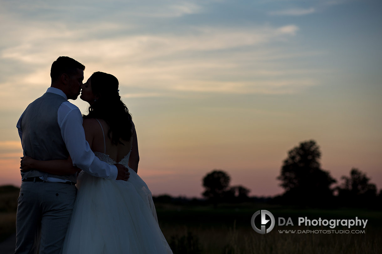 Silhouettes of a bride and groom on a golf club wedding