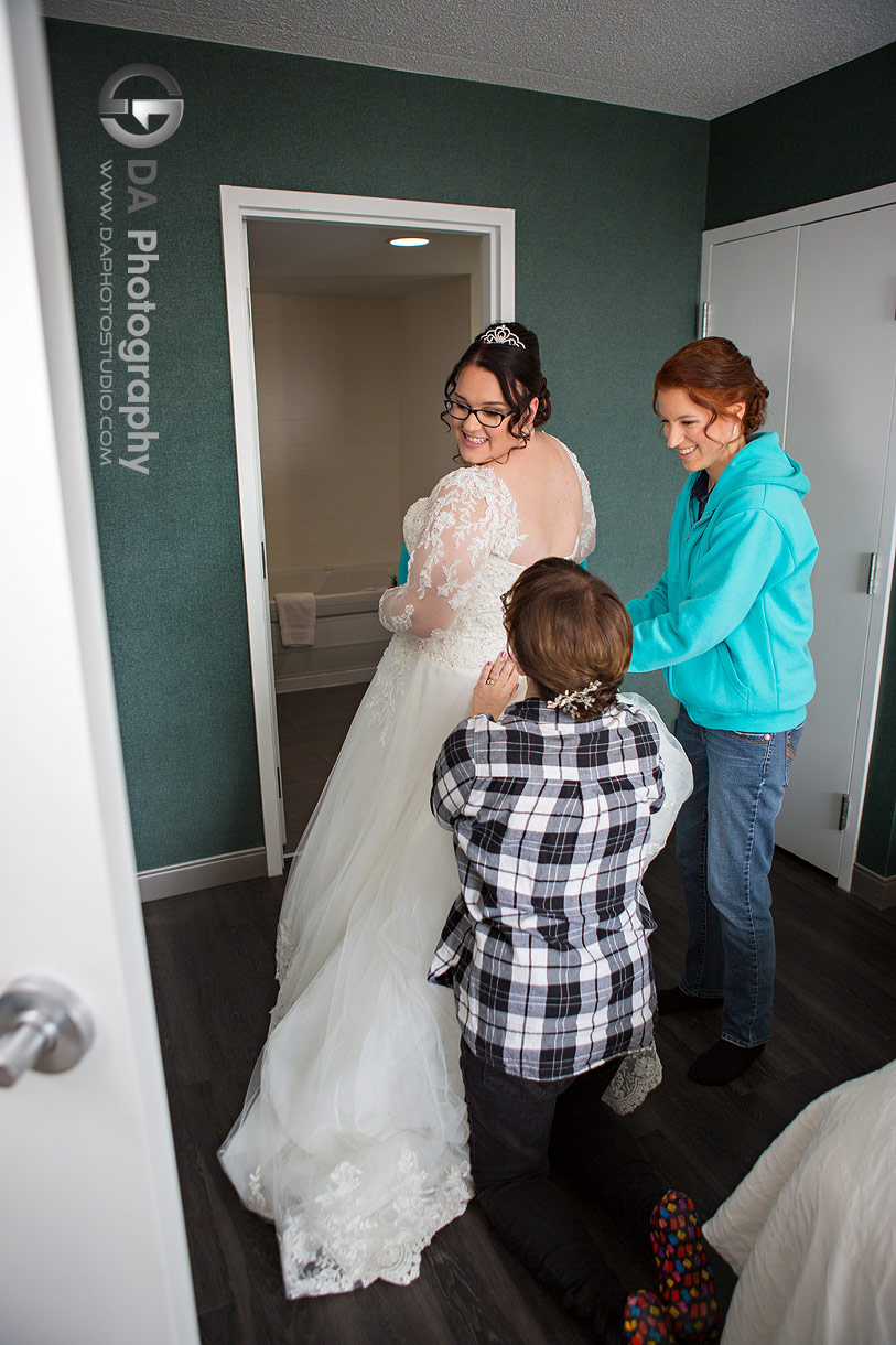 Photo of a bridesmaids helping a bride at Hilton Garden Inn in Cambridge