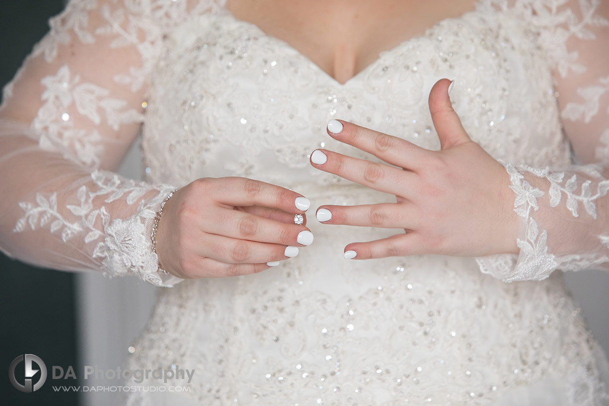 Bride adjusting her wedding ring at Hilton Garden Inn in Cambridge