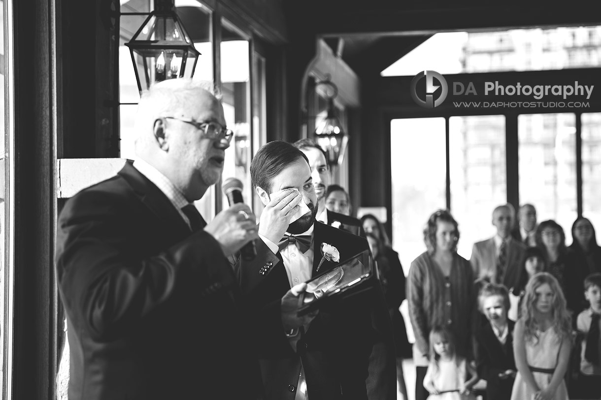 Photo of a groom wiping his tears at Cambridge Mill Wedding Ceremony