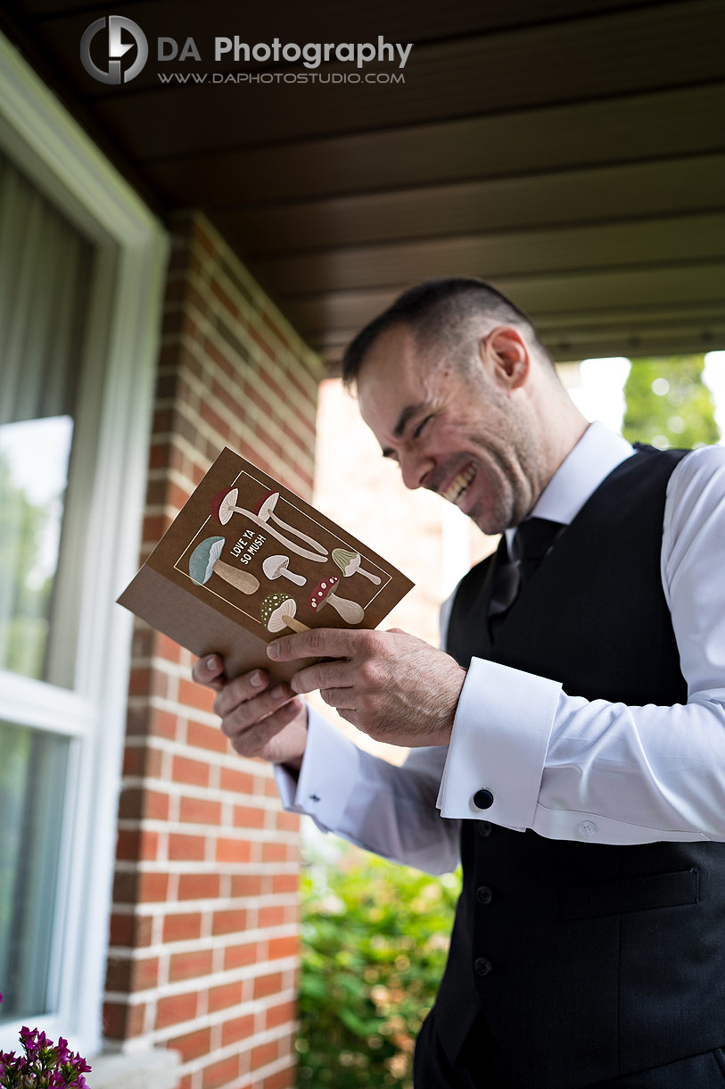 Fun photo of a Groom reading a letter from his wife to be