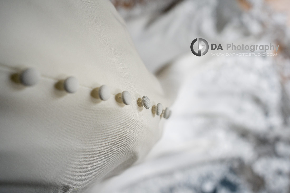 Close up photo of a buttons on a wedding dress