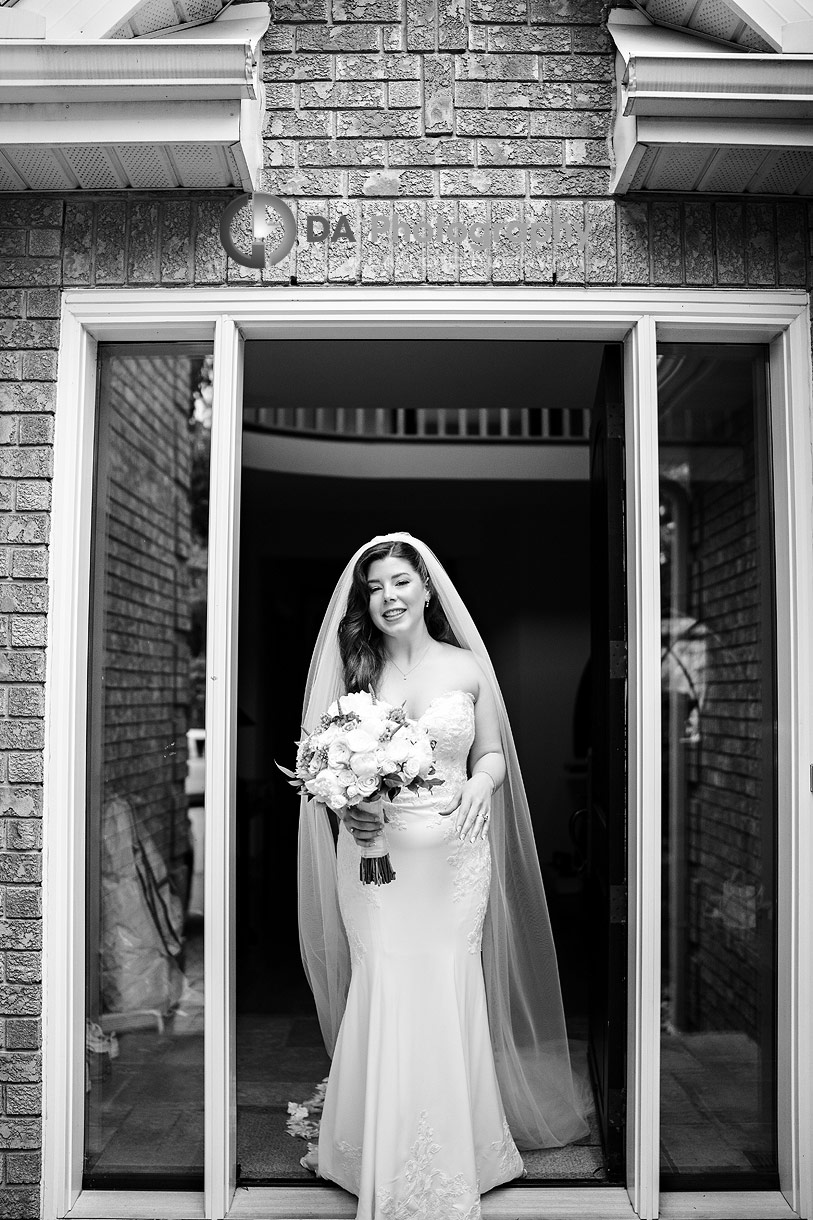 Photo of a Bride exiting the house 